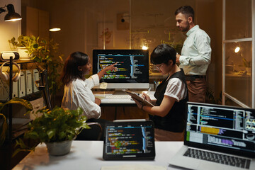 Group of developers working on programming code