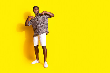 Photo of attractive stylish cheerful man wear trendy clothesc collection empty space isolated on yellow color background