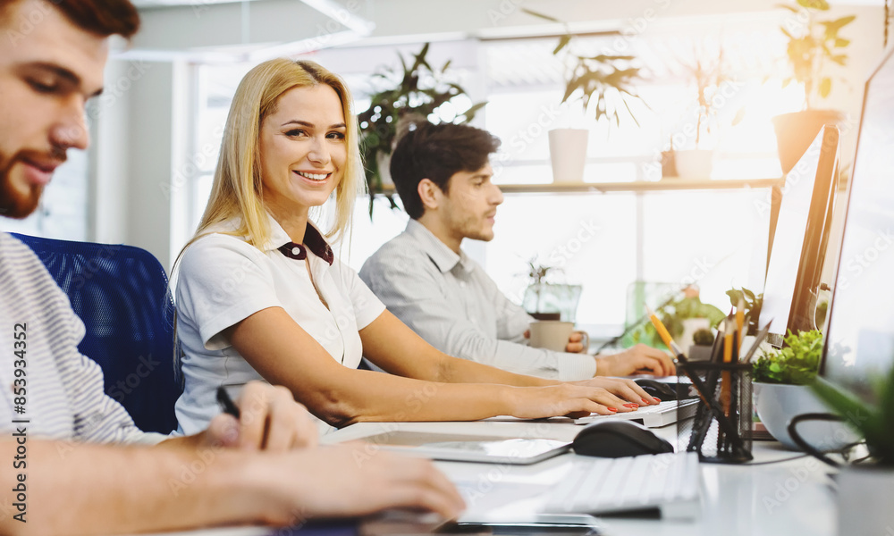 Poster a group of diverse individuals are sitting at a desk, concentrating intently as they work on their c