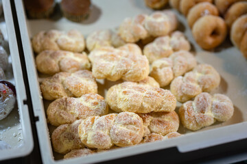Group of bread with butter and sugar are in the tray, selling at the local food market. Bakery food object photo, close-up.