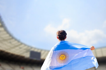 An athlete with the Argentine flag draped over their shoulders, representing Argentina in the...