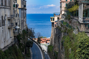 Beautiful view of the houses on the rocks and the road with the sea.