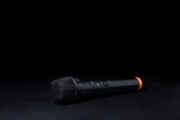 Black and silver microphones in the studio on a black and dark background. Professional recording equipment. Top view.