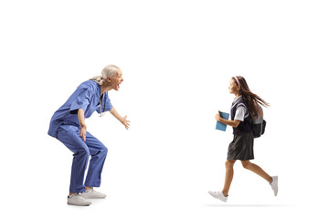 Profile shot of a happy female health care worker waiting to hug a schoolgirl