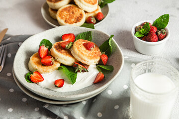 Homemade cottage cheese pancakes with sauce and strawberries. syrniki