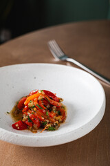 Baked bell peppers marinated with pine nuts and raisins
