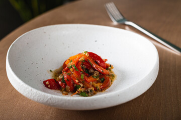 Baked bell peppers marinated with pine nuts and raisins