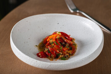 Baked bell peppers marinated with pine nuts and raisins