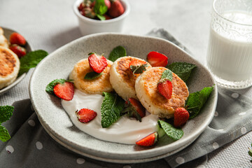 Homemade cottage cheese pancakes with sauce and strawberries. syrniki