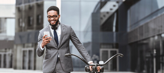 An African American businessman is on his bike in the city, checking his smartphone. The scene is energetic and modern, set against the backdrop of urban architecture.