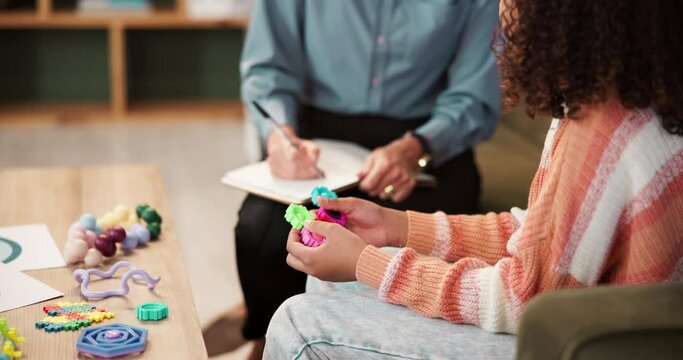 Mental health, child and talking with therapist, hands and toys for problem solving of kid. Office, service and doctor with closeup, listening and understanding of youth, psychology and notes