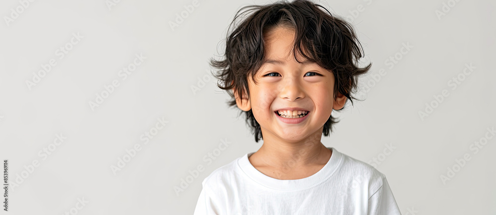 Wall mural asian boy smiling with wavy hair and  white t-shirt isolated on white background