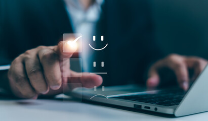 Customer service and Satisfaction concept, Businessman touching the virtual screen on the happy Smiley face icon to give satisfaction in service. rating very impressed.