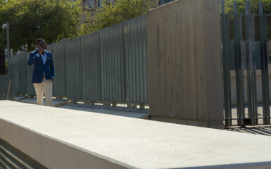 Young African American Business Man Walking with Smartphone in Financial District