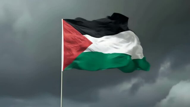The Palestinian flag waving in the wind against an overcast dramatic dark sky