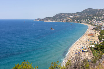 Fototapeta premium coast of Alanya in summer, crowded beach hotels near Mediterranean sea in Turkey, aerial view