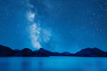 Starry night sky over tranquil mountain lake