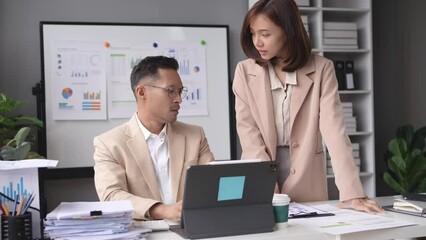 Asian woman supervisor yells or scolds a male employee for making a mistake in office. Asian female CEO who was dissatisfied with his job blamed male employee.