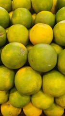 Close up pile of tasty fresh oranges sold at the market as a background.