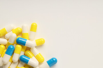 Antibiotic pills on white background, top view. Space for text