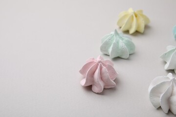 Delicious meringue cookies on light background, closeup. Space for text