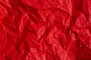 wrinkled red paper texture,Rectangular crumpled sheet of red paper on a white isolated background