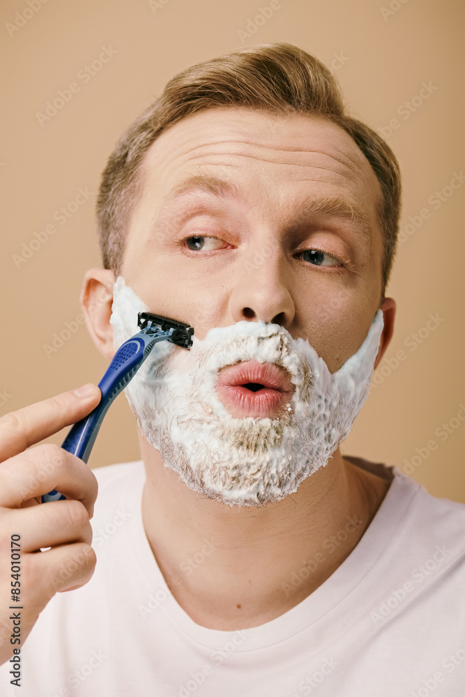 Poster A man in casual attire shaving his face with a razor.