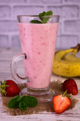 Strawberry banana smoothie in a tall glass.
