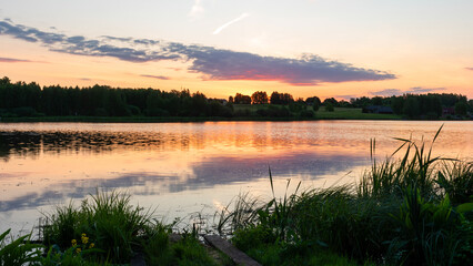 colorful sunrise, sunset landscape by the lake, brightly colored sky is reflected in the water of the lake
