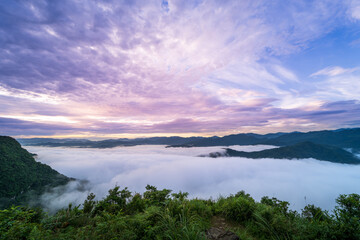 Orange sky and sea of clouds before sunrise. A peaceful, refreshing feeling. View of the mountains surrounding Emerald Reservoir. Xindian District, Taiwan.