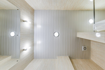 suspended ceiling with halogen spots lamps and drywall construction in empty room in apartment or...