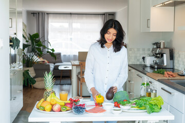 Female Indian Nutritionist expert makes healthy balanced diet plate according to proportions of...