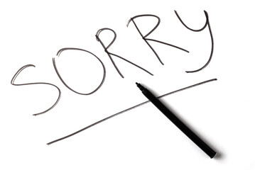The inscription SORRY on a white sheet of paper
