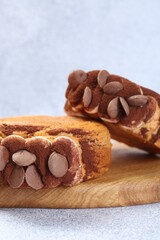 Supreme croissants with chocolate chips and cream on grey table, closeup. Tasty puff pastry