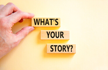 Storytelling and what is your story symbol. Concept words What is your story on blocks. Beautiful white background. Businessman hand. Business storytelling and what is your story concept. Copy space.