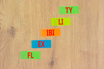 Flexibility symbol. Concept word Flexibility on beautiful colored paper. Beautiful wooden...