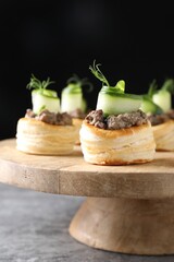 Delicious puff pastry with mushrooms, cucumber and dill on grey table