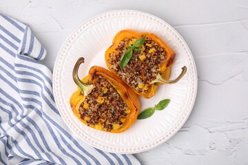 Quinoa stuffed peppers with corn and basil on white textured table, top view