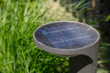 Close-up of Solar-Powered Garden Light in Greenery, Renewable Energy Concept for Sustainable Outdoor Lighting, Sunny Day Photography