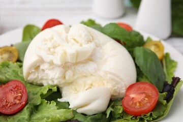 Delicious fresh burrata salad on table, closeup