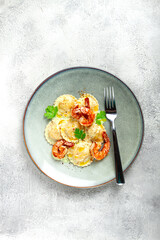 ravioli with shrimp, in cream sauce, with spices and herbs, top view, no people,