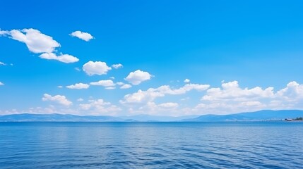 Obraz premium Endless vast blue horizons panoramic sea and sky view with white clouds stretching infinitely