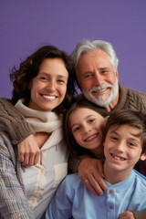 a Caucasian family smiling together on a purple studio background