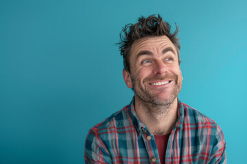 Obraz premium a Caucasian man expressing contentment on a blue studio background
