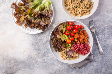 Ketogenic, paleo diet lunch bowl with grilled meat, cauliflower rice and mixed salad