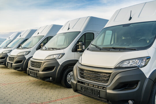 Commercial delivery vans parking in a row, transporting and shipping service company