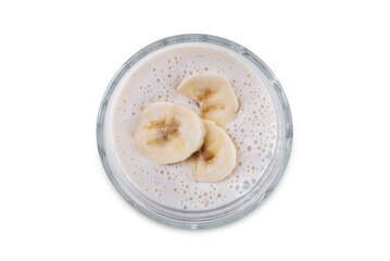 Banana milkshake with banana slices in a glass on a white isolated background