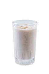 Banana milkshake with banana slices in a glass on a white isolated background