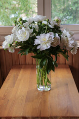 Blurred floral background. A bouquet of white peonies.