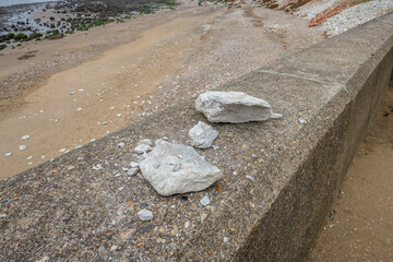 Chalk lumps placed on a wall by a cliff in Hunstanton in England